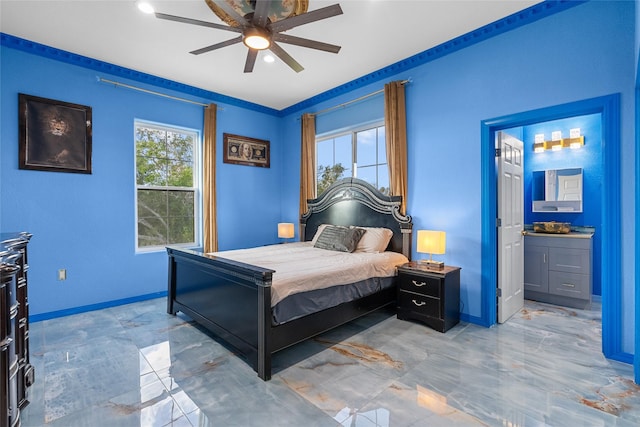 bedroom featuring ensuite bathroom, ceiling fan, and crown molding