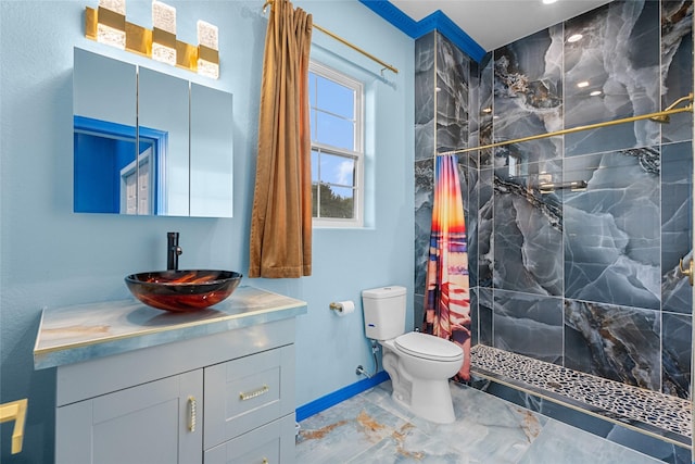 bathroom featuring toilet, vanity, and tiled shower