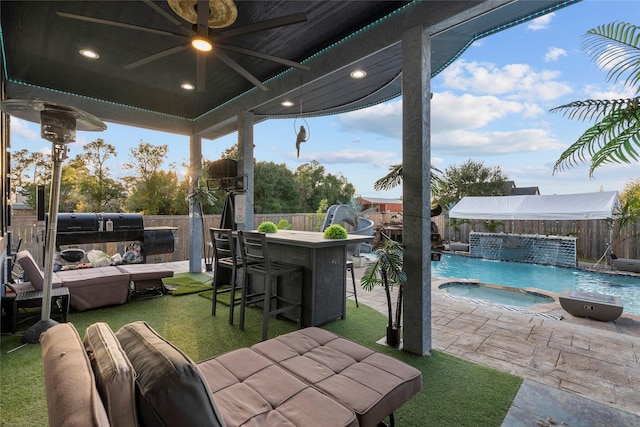 view of patio with pool water feature, a pool with hot tub, ceiling fan, and an outdoor bar