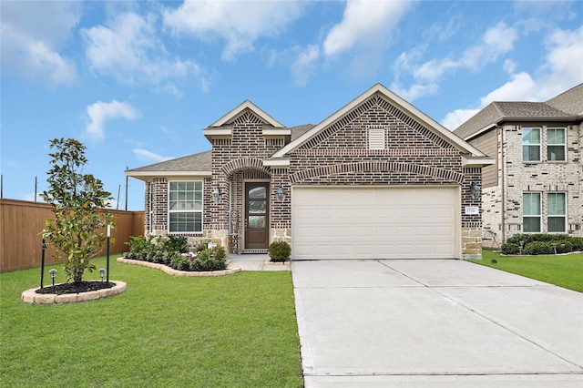 view of front of home with a garage and a front lawn