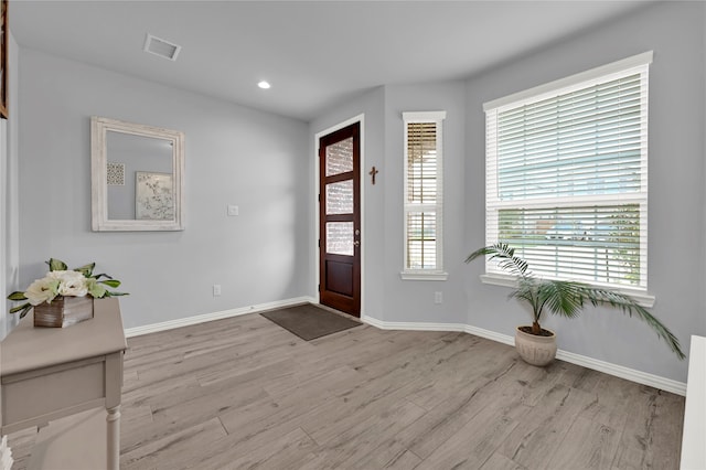 foyer entrance with light hardwood / wood-style floors