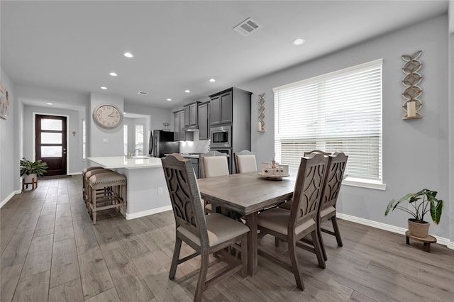 dining area with hardwood / wood-style floors and sink