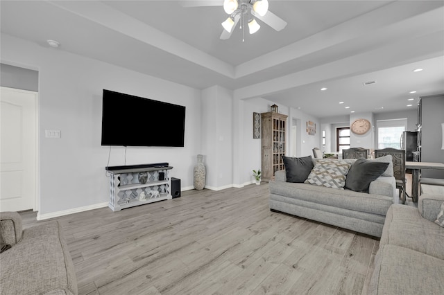 living room featuring light wood-type flooring and ceiling fan