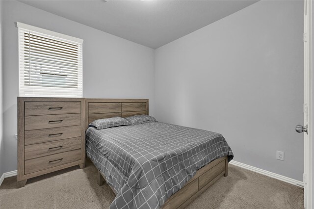 bedroom with light colored carpet