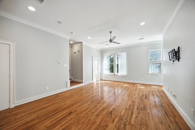 empty room with ornamental molding, ceiling fan, and light wood-type flooring