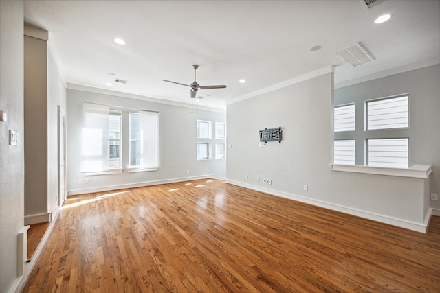 empty room with ceiling fan, crown molding, and hardwood / wood-style floors