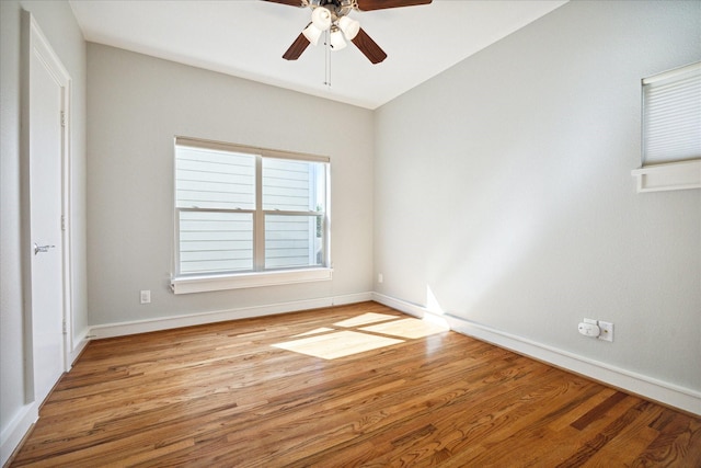 empty room with ceiling fan and light hardwood / wood-style flooring