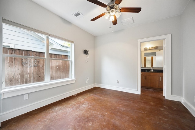 empty room featuring ceiling fan and sink