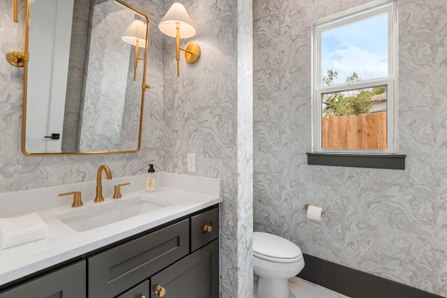 bathroom featuring toilet and vanity