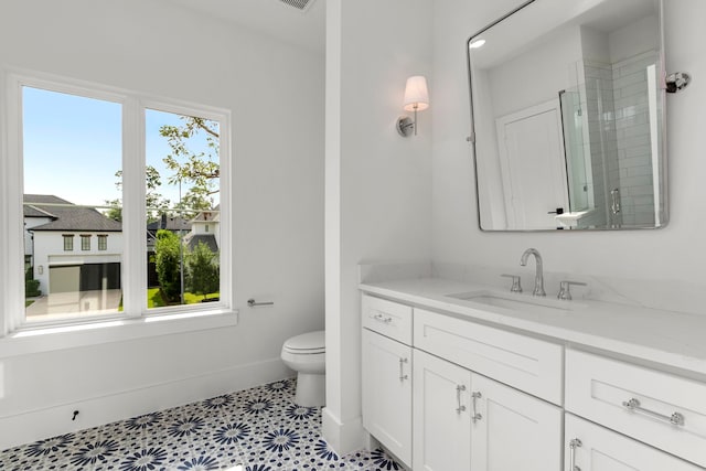 bathroom featuring vanity, toilet, tile patterned floors, and an enclosed shower