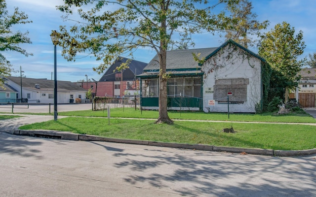 view of front of house featuring basketball court and a front yard