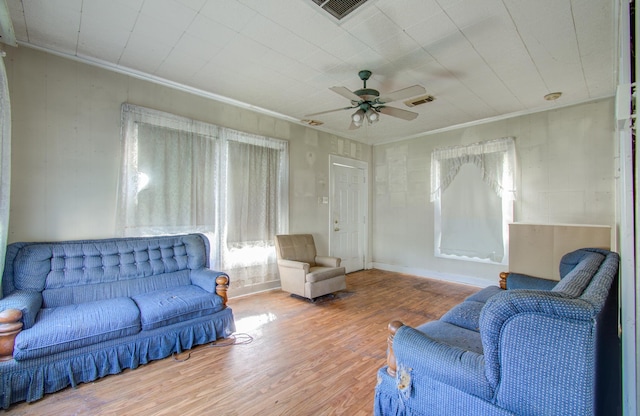 living room with crown molding, hardwood / wood-style floors, and ceiling fan