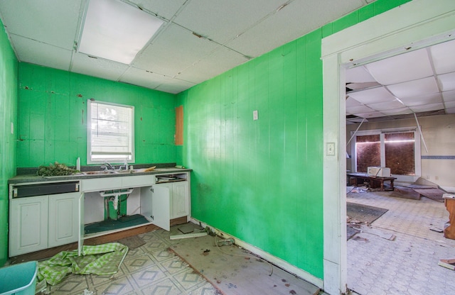 misc room with a paneled ceiling and sink