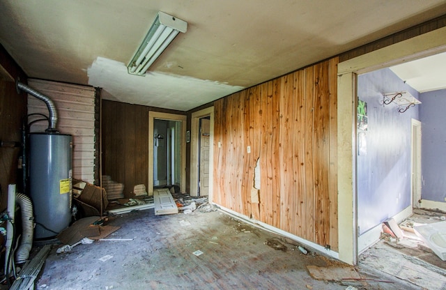 interior space with wood walls and water heater