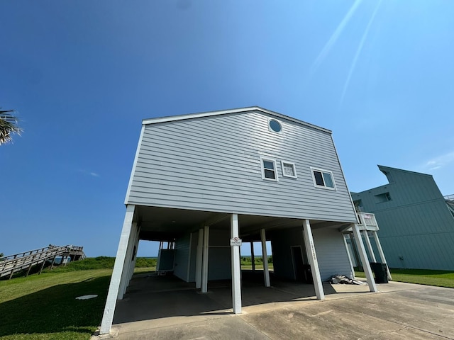 exterior space featuring a lawn and a carport