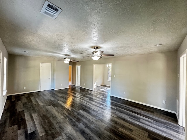 empty room with a textured ceiling, dark hardwood / wood-style flooring, and ceiling fan