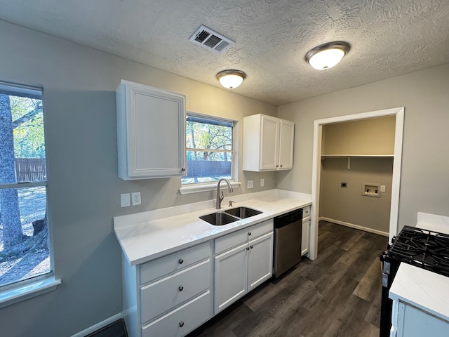 kitchen with dishwasher, sink, dark wood-type flooring, black gas range oven, and white cabinets