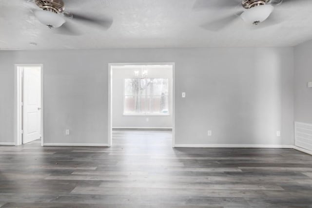 empty room featuring visible vents, ceiling fan, and wood finished floors