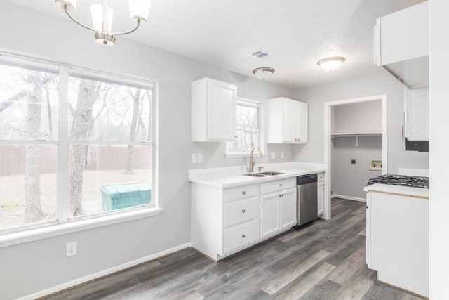 kitchen with wood finished floors, dishwasher, white cabinetry, and a sink