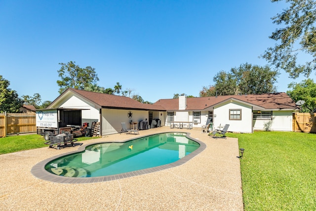 view of pool featuring a patio area and a yard