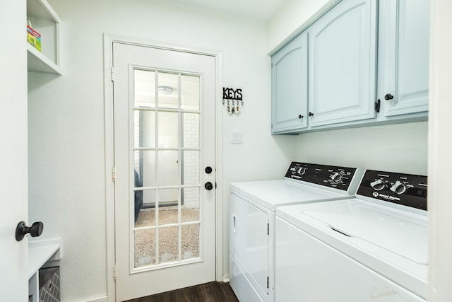 clothes washing area featuring cabinets, separate washer and dryer, and dark wood-type flooring