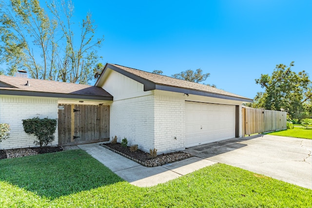 exterior space featuring a lawn and a garage