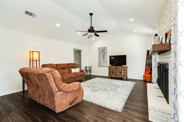 living room with a fireplace, dark hardwood / wood-style floors, ceiling fan, and lofted ceiling