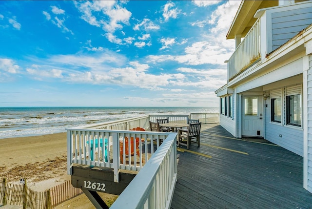 deck with a beach view and a water view