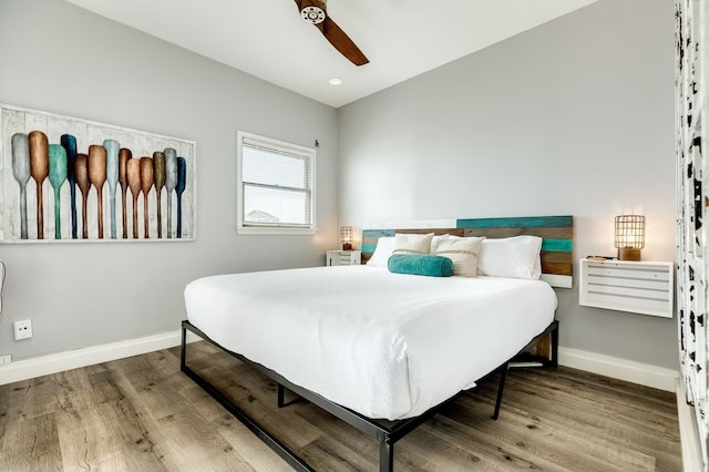 bedroom with ceiling fan and wood-type flooring