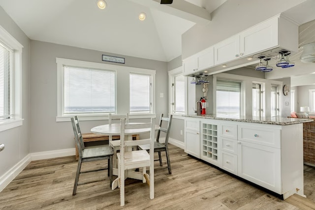 dining area with a wealth of natural light and light hardwood / wood-style flooring