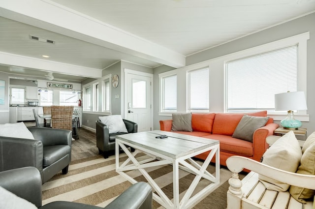 living room with hardwood / wood-style floors and beamed ceiling