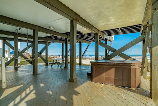 exterior space with a water view and a hot tub