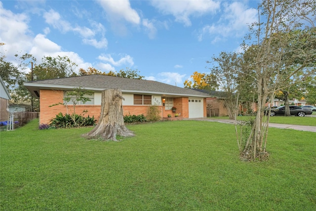 ranch-style home featuring a front lawn and a garage