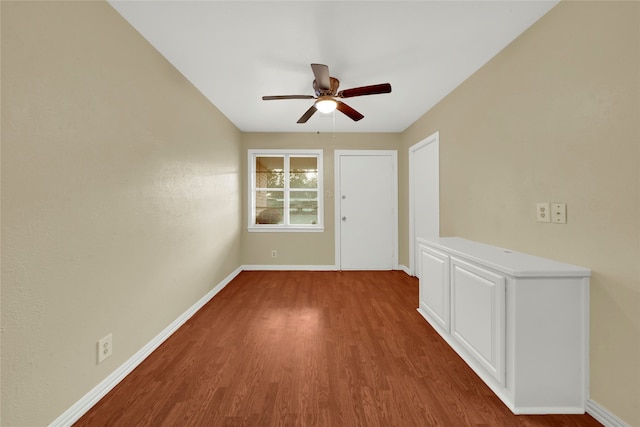 empty room featuring ceiling fan and dark hardwood / wood-style flooring