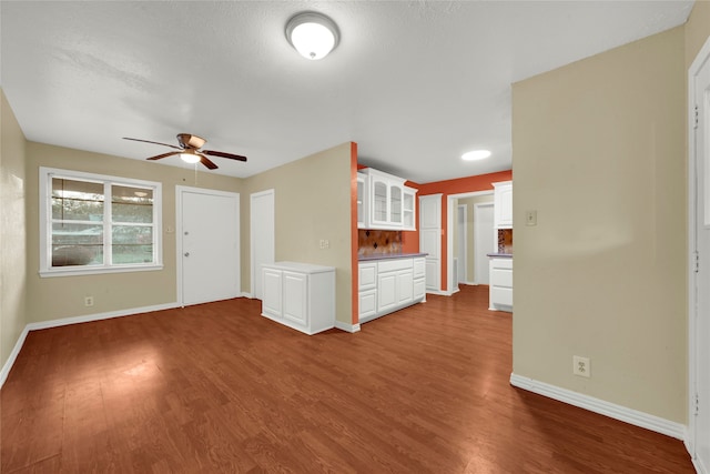 unfurnished living room featuring hardwood / wood-style floors and ceiling fan