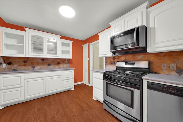 kitchen featuring stainless steel appliances, light wood-type flooring, tasteful backsplash, and white cabinetry