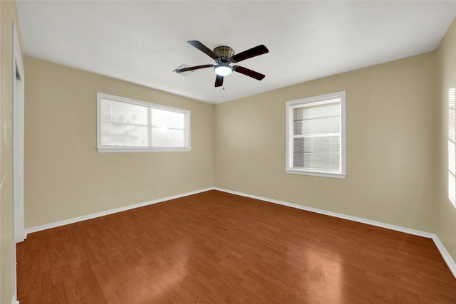 spare room with ceiling fan and wood-type flooring