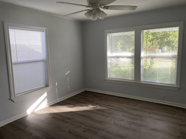 empty room featuring ceiling fan and dark wood-type flooring