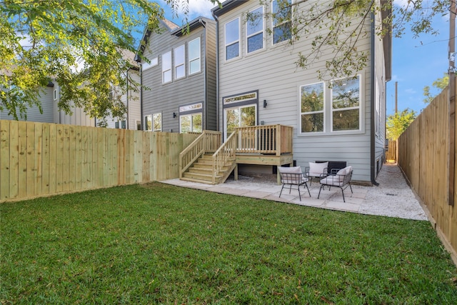 back of property with an outdoor living space, a deck, a yard, and a patio