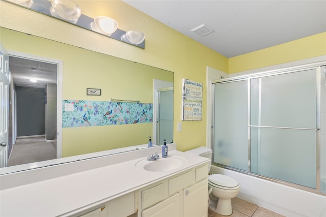 full bathroom featuring tile patterned floors, vanity, toilet, and bath / shower combo with glass door