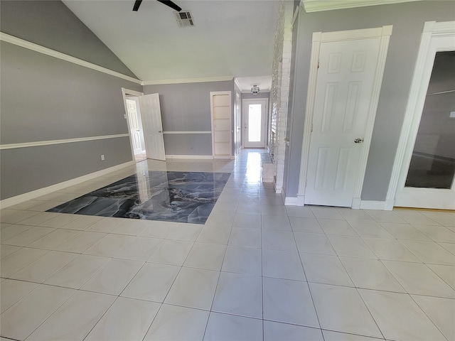 unfurnished room featuring crown molding, light tile patterned floors, and lofted ceiling