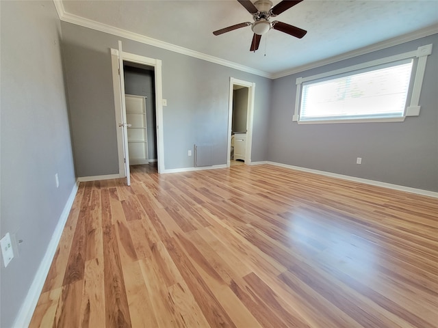 unfurnished bedroom featuring ceiling fan, light wood-type flooring, and crown molding