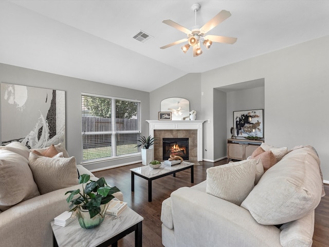 living room with a fireplace, ceiling fan, dark wood-type flooring, and vaulted ceiling