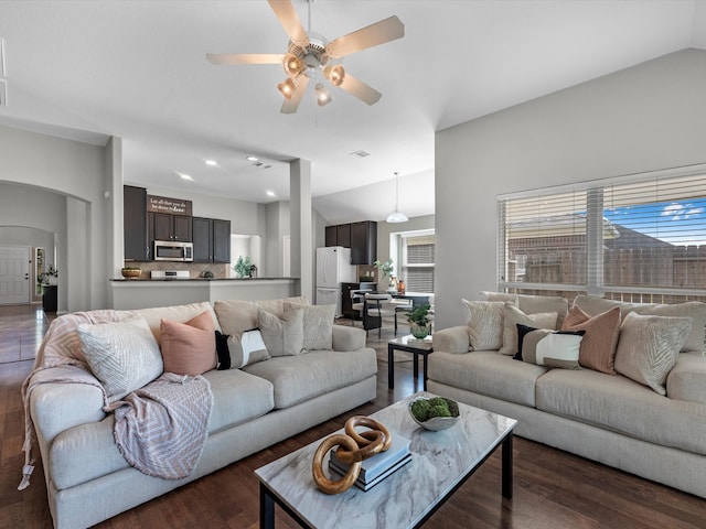 living room with dark wood-type flooring, ceiling fan, and lofted ceiling