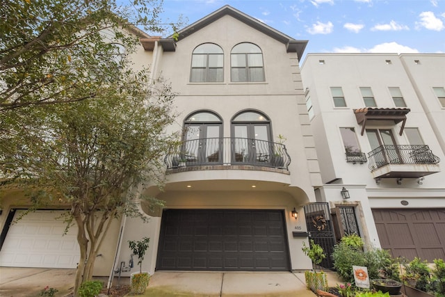 townhome / multi-family property featuring a balcony and a garage