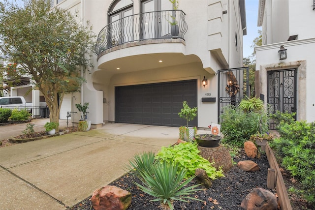 view of front facade featuring a balcony and a garage