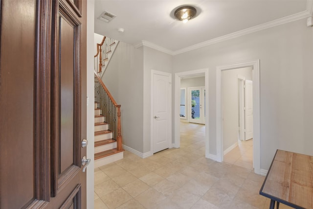 entryway featuring crown molding