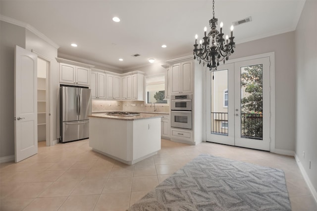 kitchen with sink, stainless steel appliances, tasteful backsplash, crown molding, and light tile patterned flooring