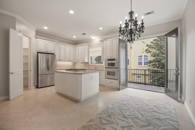 kitchen featuring sink, stainless steel appliances, crown molding, decorative backsplash, and white cabinets