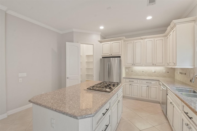 kitchen with decorative backsplash, appliances with stainless steel finishes, light tile patterned floors, and sink